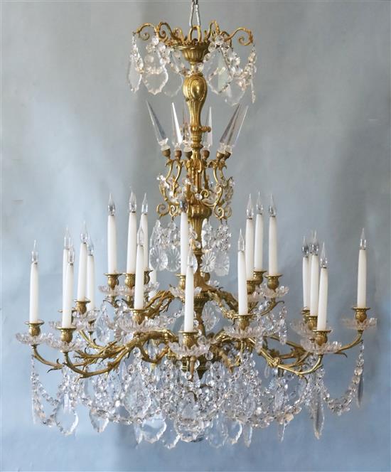 A Louis XV style ormolu and cut glass twenty four light chandelier, Diam.3ft 2in. Drop 4ft 2in.